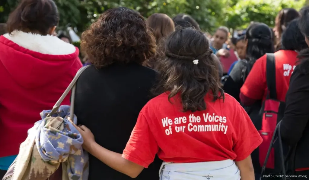 A mother and daughter standing together at a community demonstration