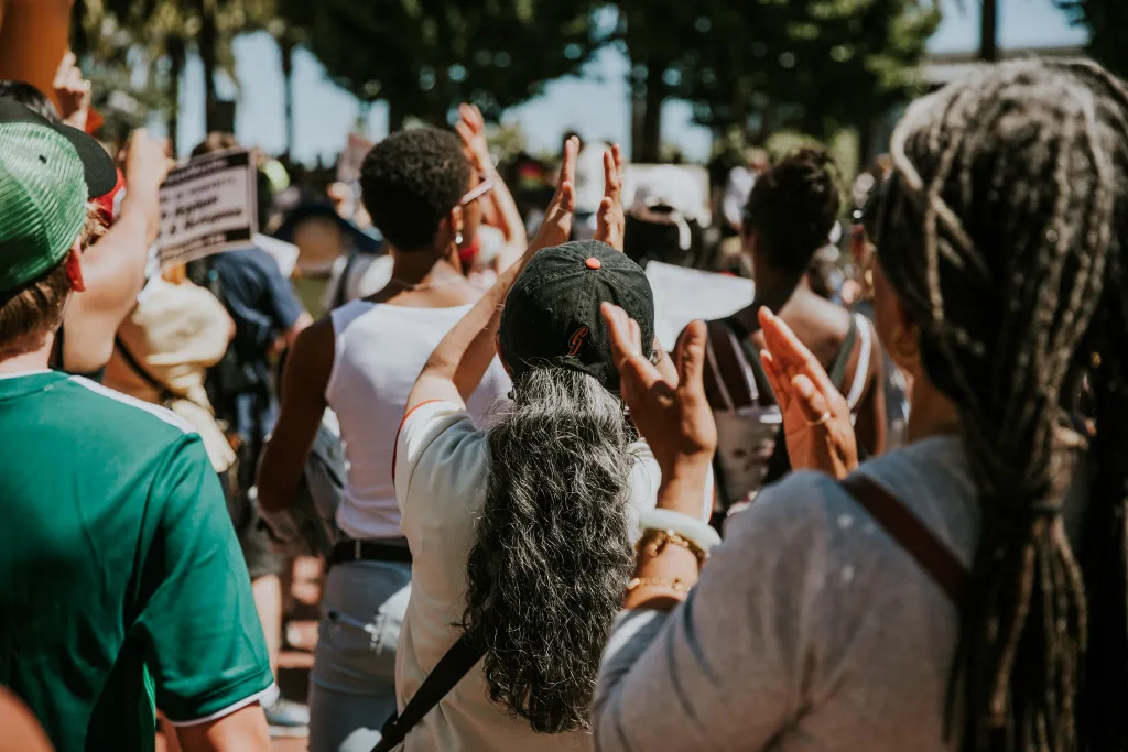 Group of demonstrators with their hands raised