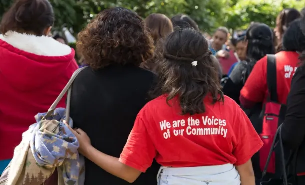 A mother and daughter standing together at a community demonstration