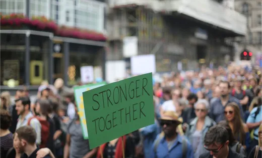 A sign held by a demonstrator reading "Stronger Together"