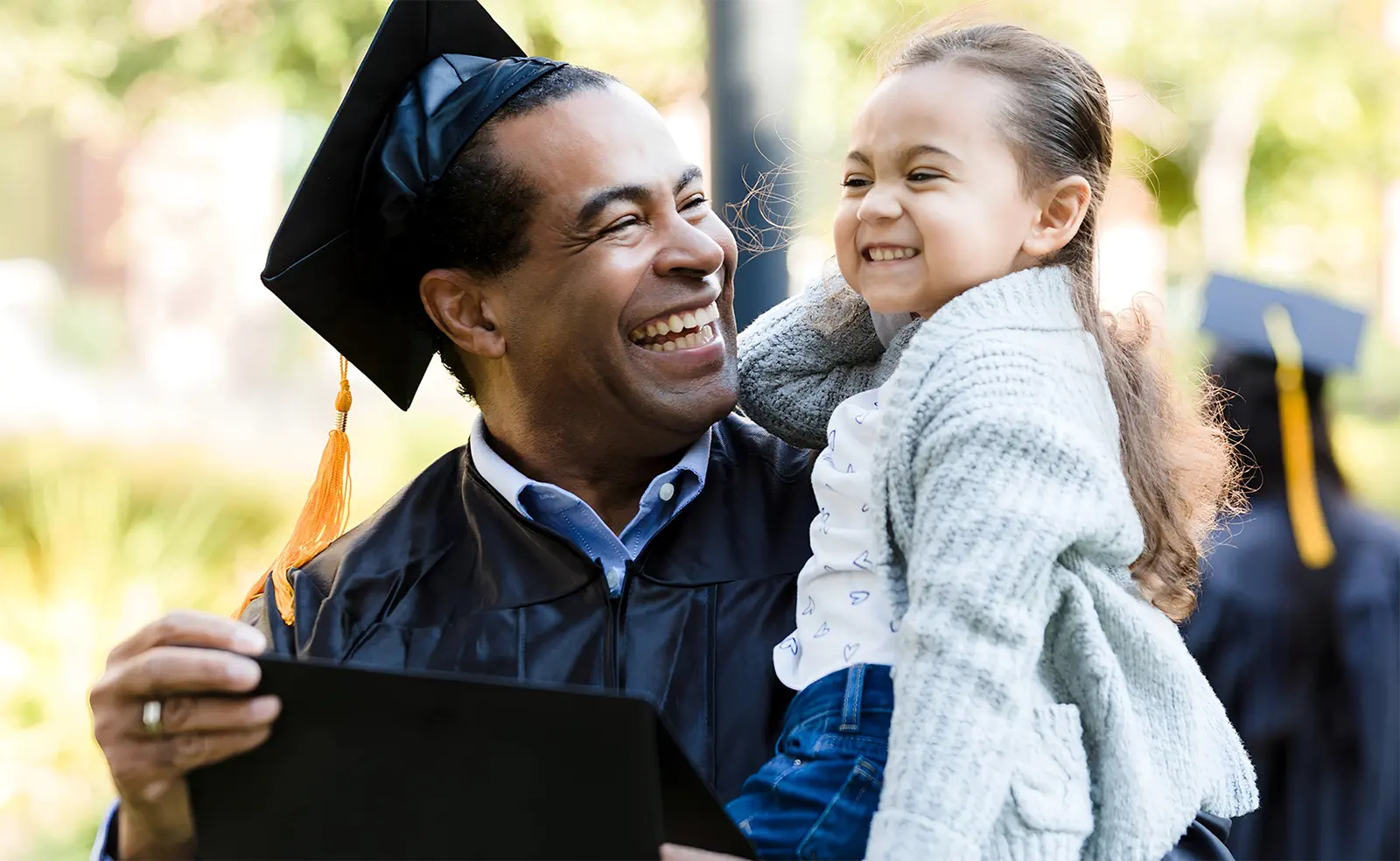 Parent with his daughter at college graduation