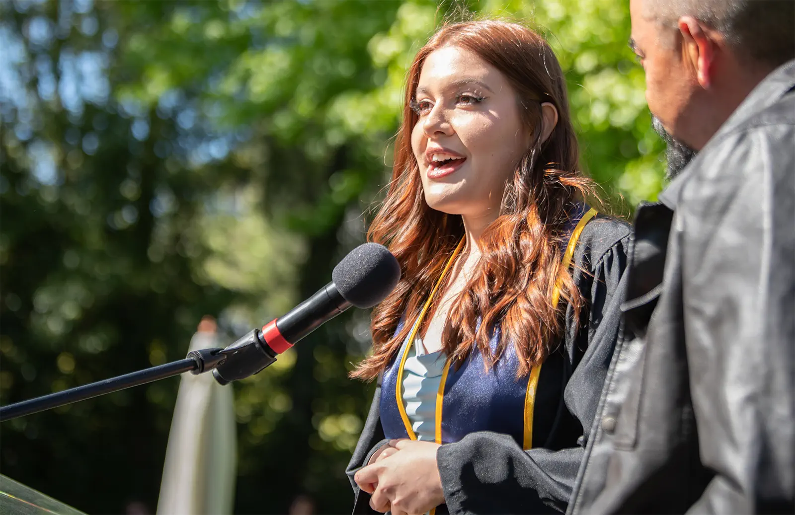 Woman speaking at college graduation ceremony